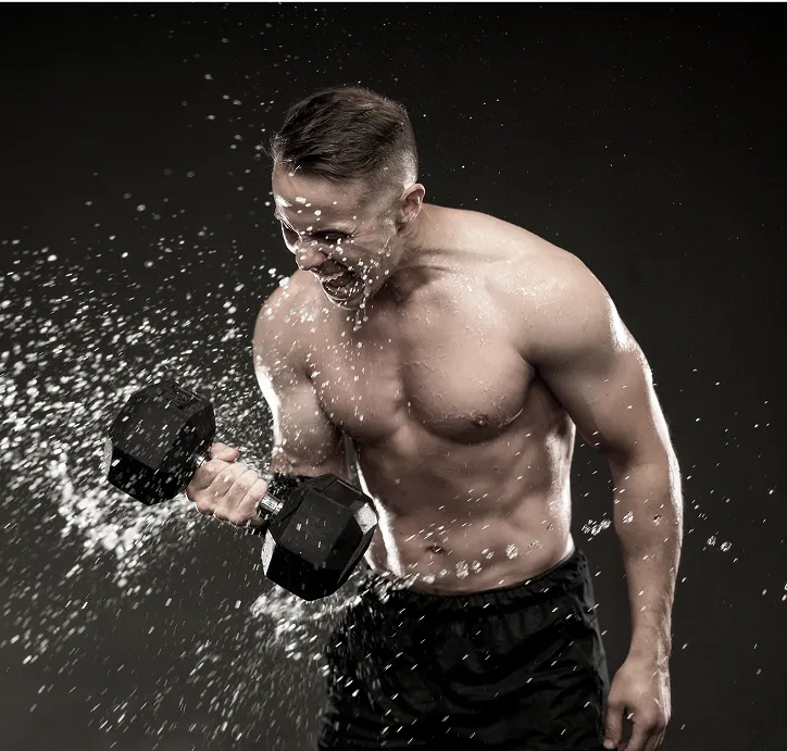 Athlete splashing water on chest after intense workout.
